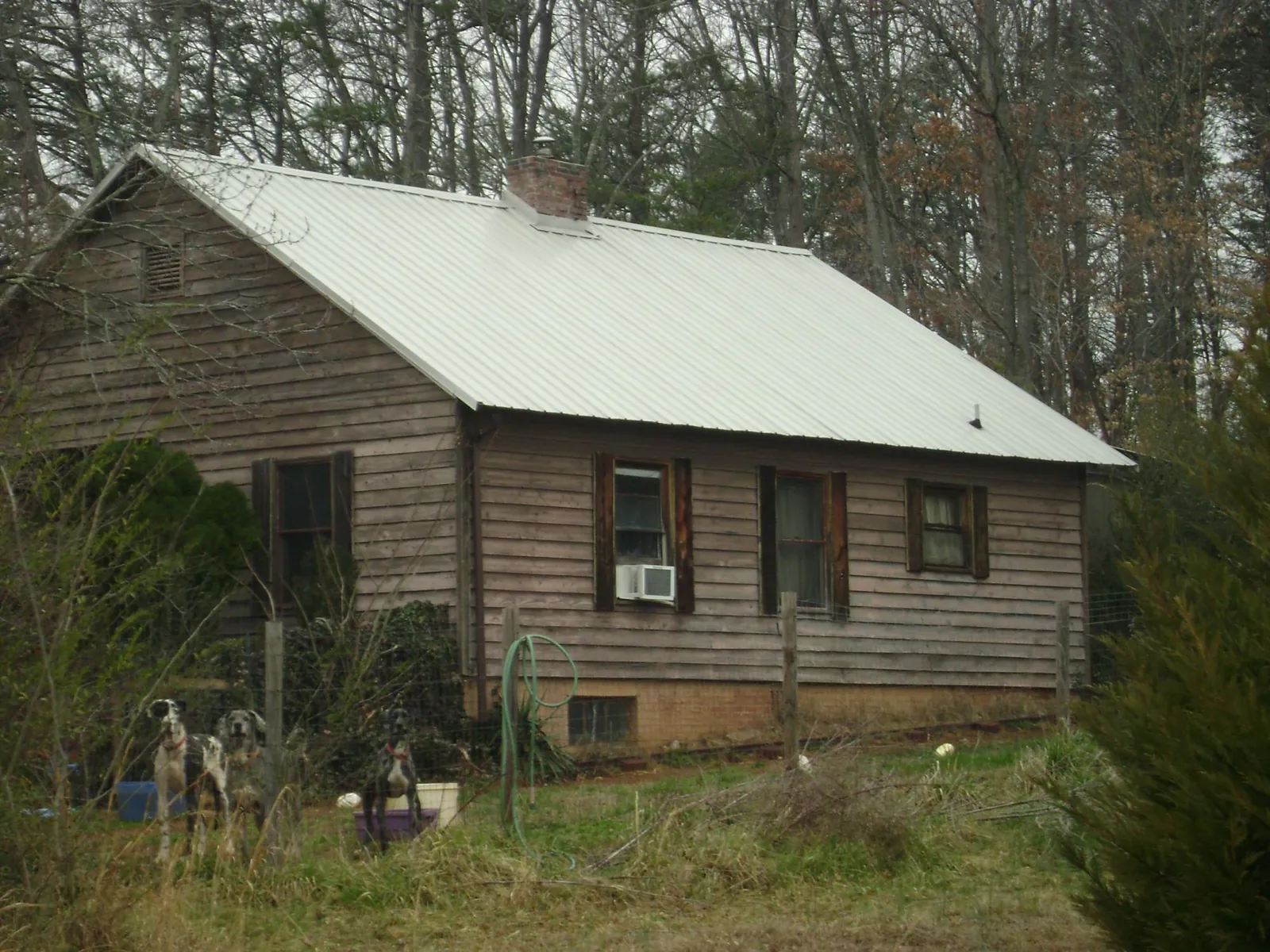 White metal roof on an old wood sided farmhouse, from a Metal Roof Installation job in Ayer