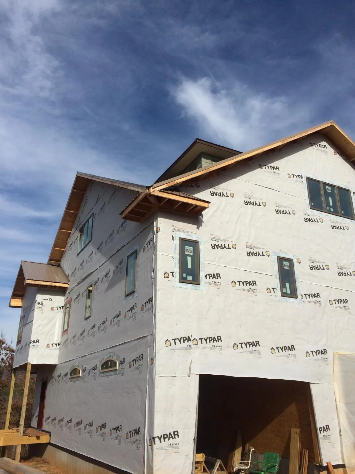 Stick built house wrapped in Typar with new roof framing and dormers in Ayer